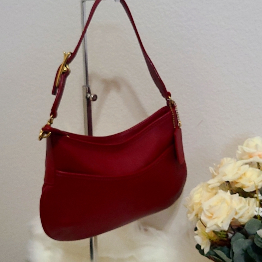 Small red coach purse. Genuine leather, used for occasions. Holds all essentials